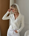 Detailed macro view of white ribbed knit fabric and metallic front zipper closure - S / White