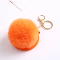 Detail of bright orange faux rabbit fur pompom keychain with golden metal ring and clasp - Orange With Fur Ball