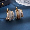 Macro shot of multi-layer intertwined hoop earrings with colorful pavé cubic zirconia - Two-Tone Gold