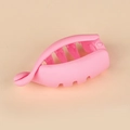 Pink matte plastic banana hair clip for high ponytail styling on beige background - Pink