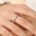 Close-up of 2mm silver titanium steel thin ring shown on a model's hand - US 10 / 2mm / Silver