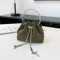 Close-up of black mini bucket bag with iridescent rhinestones and metal ring handle - Gold