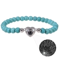 Detail of blue turquoise bead bracelet with silver heart projector stone showing I Love You - Heart-Turquoise
