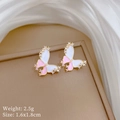 Macro shot of pink butterfly stud earrings with sparkling cubic zirconia in gold plating - Butterfly Stud Earrings (P428)