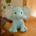 Sky blue plush elephant soft toy sitting on a wooden surface for baby comfort - Light Blue With White Ear Core
