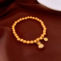 Detail of 18k gold plated bracelet featuring opal beads and a sparkling lucky bag charm - Frosted Gold - Lucky Bag & Coin