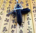 Macro detail of hexagonal black agate stone pendants with silver metal clasps on bamboo - Obsidian