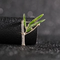Close-up of elegant bamboo-shaped brooch with clear rhinestones and green enamel leaves - Bamboo Brooch