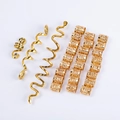 Detail of gold Viking hair coils and Celtic spiral charms for braids on white background - Gold