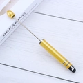 Golden touchscreen beadable pen with stylus tip on a professional wooden office desk - Amber Yellow