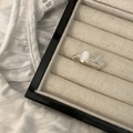 Silver minimalist ring with oval white gemstone in a beige jewelry display box - Oval White Gemstone Ring (J4204)
