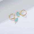 Detail of gold evil eye hoop earrings with blue enamel and white zircon stone - 925 Silver / Turquoise