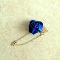 Elegant navy blue rose lapel pin with a gold leaf and delicate hanging chain detail - Sapphire Blue