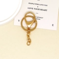 DIY jewelry kit featuring golden keychain rings, lobster clasps, and links on a desk - Gold 4-Section Chain Lobster Clasp / Gold