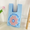 Light blue knitted handbag featuring pink floral pattern and spring text design - Blue Disk Flower Bag