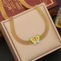 Elegant gold-plated mesh butterfly necklace displayed on a beige gift jewelry box - Necklace