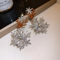 Detailed macro view of reindeer snowflake earrings with sparkling zircon inlay - Silver Enamel Reindeer Rhinestone Earrings