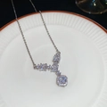 Detail of square zircon diamond necklace pendant on a white ceramic plate - Necklace - Silver