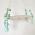 Detail of mint green tassel and geometric wood beads on a hanging wall shelf - Mint Green
