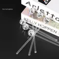 Close-up of clear cocktail stirrers with silver 3cm disco ball toppers on black surface - 3cm Mirror Ball Stirrer