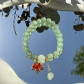 Elegant green jade beaded bracelet with a red maple leaf pendant and gold accents - S048-red Maple Leaf Donglin Jade Beaded Bracelet #sz340