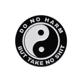 Detail of round enamel brooch featuring black and white Yin Yang design with slogan text - Tai Chi Yin Yang Style (XZ8728)