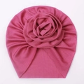 Detailed view of the pink baby turban hat featuring a large 3D rose and ribbed texture - Rose Red