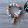 Colorful silicone pumpkin bead keychain with orange tassel and golden lobster clasp - Coral