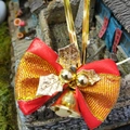 Close-up of a festive Christmas bow with gold bells and leaves for gift wrapping and pets - Christmas Bow 12