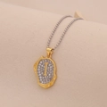 Macro shot of gold letter I pendant with rhinestones on a silver bead chain - Letter I