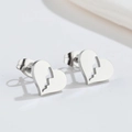 Macro detail of silver heart stud earrings with unique lightning cutout design - 527 Broken Heart - Steel