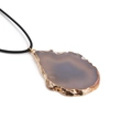 Macro detail of natural agate slice pendant with gold plated edges on black leather cord - Gray