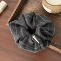 Detail of grey striped fabric hair scrunchie with soft cotton-linen texture on wooden tray - Striped/Herringbone Texture / Dark Gray