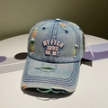 Close-up of pink 3D embroidery and distressed ripped details on blue denim baseball cap - Adjustable / Pink Letter