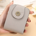 Mini light grey makeup bag with mirror and golden daisy clasp in textured leather - Gray