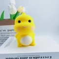 Cute yellow dinosaur night light toy with pink cheeks placed on a book for kids - Yellow Dragon