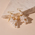 Detailed shot of baroque grape earrings featuring white imitation pearls and gold leaves - White Grape Pearl Tassel Ear Hook