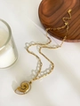 Macro view of 18K gold starfish and seashell pendant necklace with sparkling crystal details - Gold Conch Style