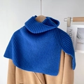 Detail van blauwe gebreide coltrui sjaal met ribbeltextuur op een camel wollen jas - Koningsblauw