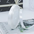 Glossy white 1cm satin ribbon roll for gift wrapping and DIY crafts on marble backdrop - Natural White