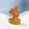 Miniature resin reindeer figurine with festive green wreath and red berries detail - Green Christmas Reindeer
