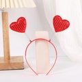Detail view of red sequin heart headband with flexible springs on a white display stand - Red Sequin Heart