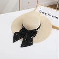 Detailed close-up of straw sun hat featuring a black ribbon bow with pearl accents - M / Beige