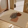 Abstract leaf pattern TPR entrance mat on wooden floor in a minimalist entryway setting - 40*60cm / Beige Leaf
