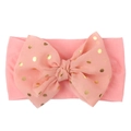 Detailed view of pink baby headband featuring a large gold polka dot lace bow - Pink