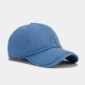 Close-up of distressed blue washed cotton baseball cap with frayed edges and retro details - Adjustable / Light Blue