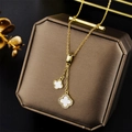 Golden titanium steel clover necklace with cubic zirconia tassels on a jewelry box - 863 Gold And White