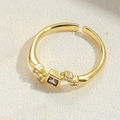 Adjustable golden ring with a square purple gemstone and small side crystals - Brown Zirconia