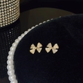 Elegant gold bow earrings with micro-set cubic zirconia and white pearls on black velvet - A856 Gold-Pave Bowknot Pearl