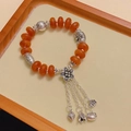 Vintage agate bead bracelet with orange beads, silver charms, and elegant floral tassels - Flat Round Amber: Auspicious Elephant Flower Four Tassels Bracelet
